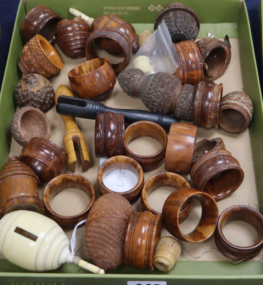 A 19th century ivory humming top, a coquilla nut humming top and a group of coquilla nut carvings and napkin rings